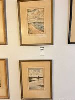 Pair of framed watercolors hung vertically on wall