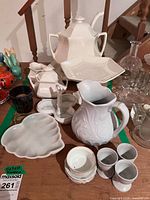 Group shot showing tureen, square bowl, pitcher, sugar bowl, creamer, relish dish, shell plate, ramekin, egg cups, and small dishes