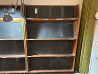 Full front view of bookshelf showing five shelves and chalkboard back