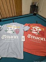 Back view of both shirts displaying large skull graphics