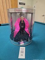 Front view of sealed Happy Holidays Barbie in cylinder box