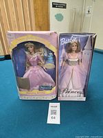 Front view of both boxed Barbie dolls