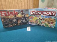 Risk and Monopoly boxes side by side on table