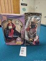 Both boxed dolls side by side