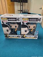 Front view of two boxed Sidney Crosby Pop! figures on table