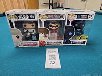 Front view of the three Funko Pop! boxes showing characters and numbers