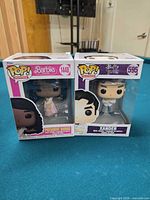 Both Funko Pop figures side by side on table