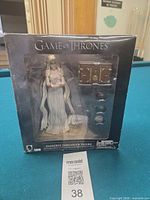 Front of sealed box showing figure and accessories