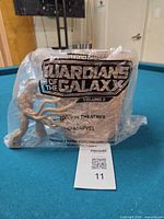 Front view of sealed Groot popcorn container with Guardians of the Galaxy Volume 3 logo on bag