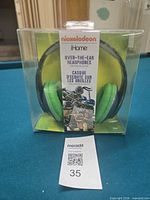 Front of sealed retail box showing headphones and branding