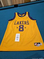 Front view of yellow Lakers #8 Kobe Bryant jersey laid flat