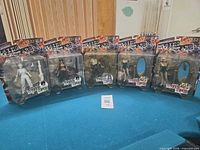 Front view of six sealed Rising Stars action figures on table