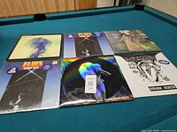 All six records laid out on pool table