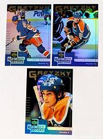 Three Gretzky foil cards laid out
