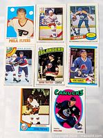 All eight anniversary hockey cards laid out