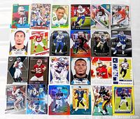 Overall view of all 24 football cards laid out in four rows