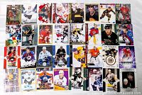 Overhead view of all 32 hockey cards laid out in four rows