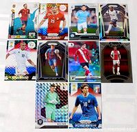Nine foil soccer cards arranged in three rows