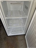 Interior view showing wire shelves and basket