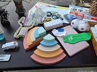 table view showing bookends, placemats, eyewear, foot gauge, bagged lights