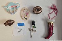 All six decorative items laid out: butterfly trinket box, stocking ornament, agate, teabag rest, marble inlay, rose hook