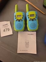pair of blue-green walkie-talkies with manual
