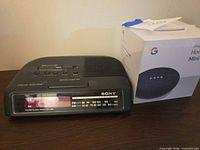 Sony Dream Machine clock radio beside boxed Google Home Mini