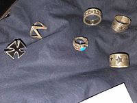 All six rings laid out showing designs