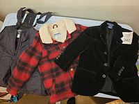 All three garments laid out: WFS snow bib, Old Navy flannel jacket, Polo velvet blazer