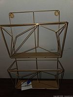 Front view showing two geometric wire pockets and keyhole mounts