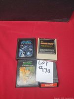 Four cartridges stacked—Asteroids, Mouse Trap, Berzerk, Snafu