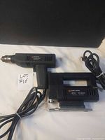 Both Black & Decker corded drill and jigsaw with cords visible