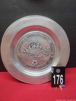 Front of commemorative plate showing relief design and text