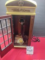 Full view of phone box open showing telephone and rotary dial