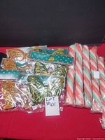Candy cane poles bundled beside packaged butterfly ornaments
