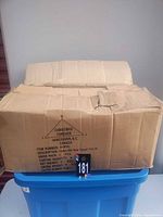Sealed cardboard shipping case on bin
