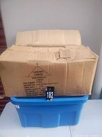 Sealed cardboard case on blue tote