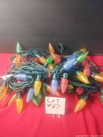 Tangled bundle of two green-wire strands showing multicolour faceted LED bulbs