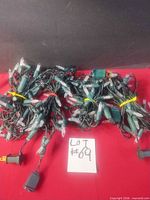 Four bundled LED light strands on table with lot card visible