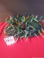 Tangled strands of multi-coloured LED lights on green wire