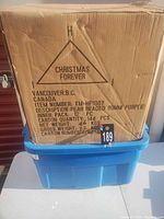 Full sealed carton on blue tote showing branding and item details