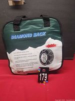 Front view of carry bag showing Diamond Back branding and tire chain illustration