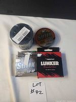 All four unopened fishing line reels grouped