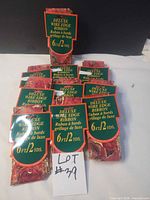 Stack of ten packaged deluxe wire edge ribbons showing labels