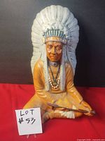 Front view of seated chief statue with item number card