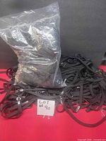 Bag and loose pile of numerous black lanyards with note showing lot