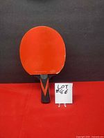 Front view showing red rubber face with plastic film