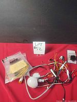 Overview of lot showing sealed MRO bags, wiring harness with LEDs and white dome sensor