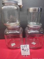 Front view of four glass jars showing shapes and lids