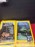 Two magazine covers displayed plus part of stack